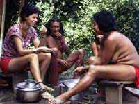 Carole eats acai berries with Wayana friends, French Guiana